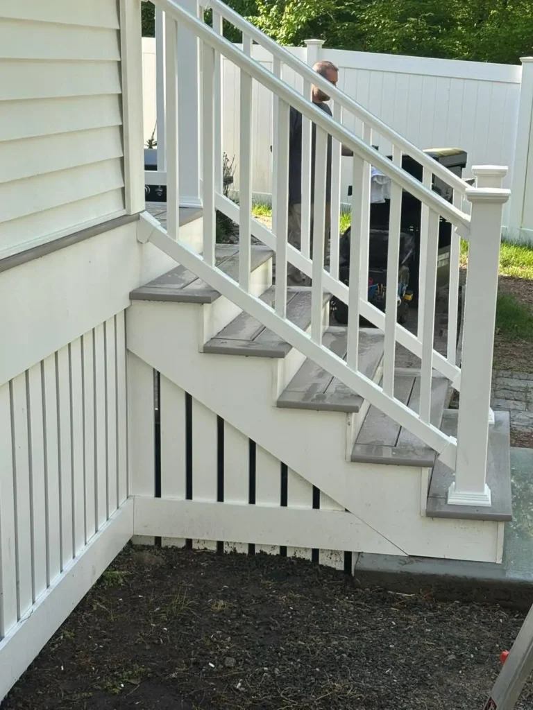 Exterior stairs with white railing and balusters