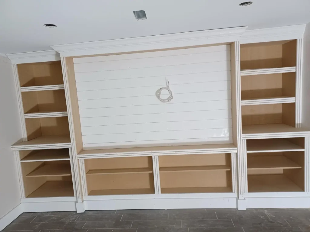 Custom built-in entertainment wall with shiplap panel and shelving