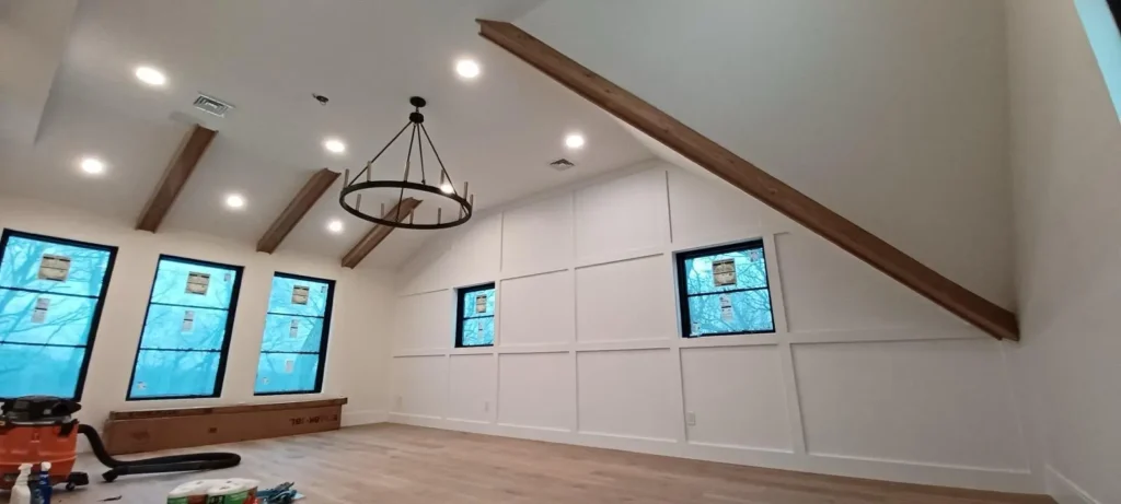 Great room with board-and-batten wall paneling and ceiling beams